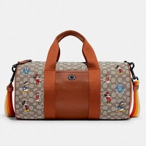 DISNEY X COACH DUFFLE BAG -  SIGNATURE TEXTILE JACQUARD MICKEY MOUSE AND FRIENDS